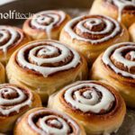 Gooey cinnamon rolls with heavy cream, fresh out of the oven