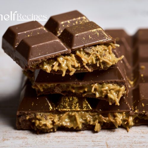 A close-up image of a rich, dark chocolate bar with a delectable filling of caramel and shredded coconut. The chocolate is smooth and glossy, with a hint of gold dust adding a touch of luxury. This is a Dubai chocolate bar, known for its exquisite combination of flavors and textures.